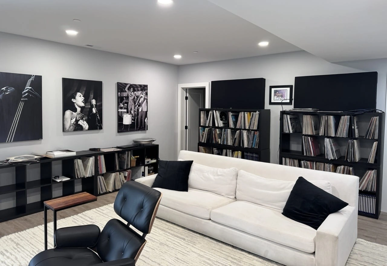 Finished basement with a sofa, vinyl wood floor, and recessed lights