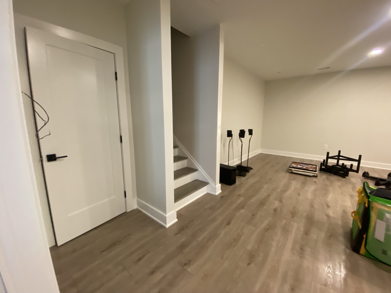 Finished basement with a sofa, vinyl wood floor, and recessed lights