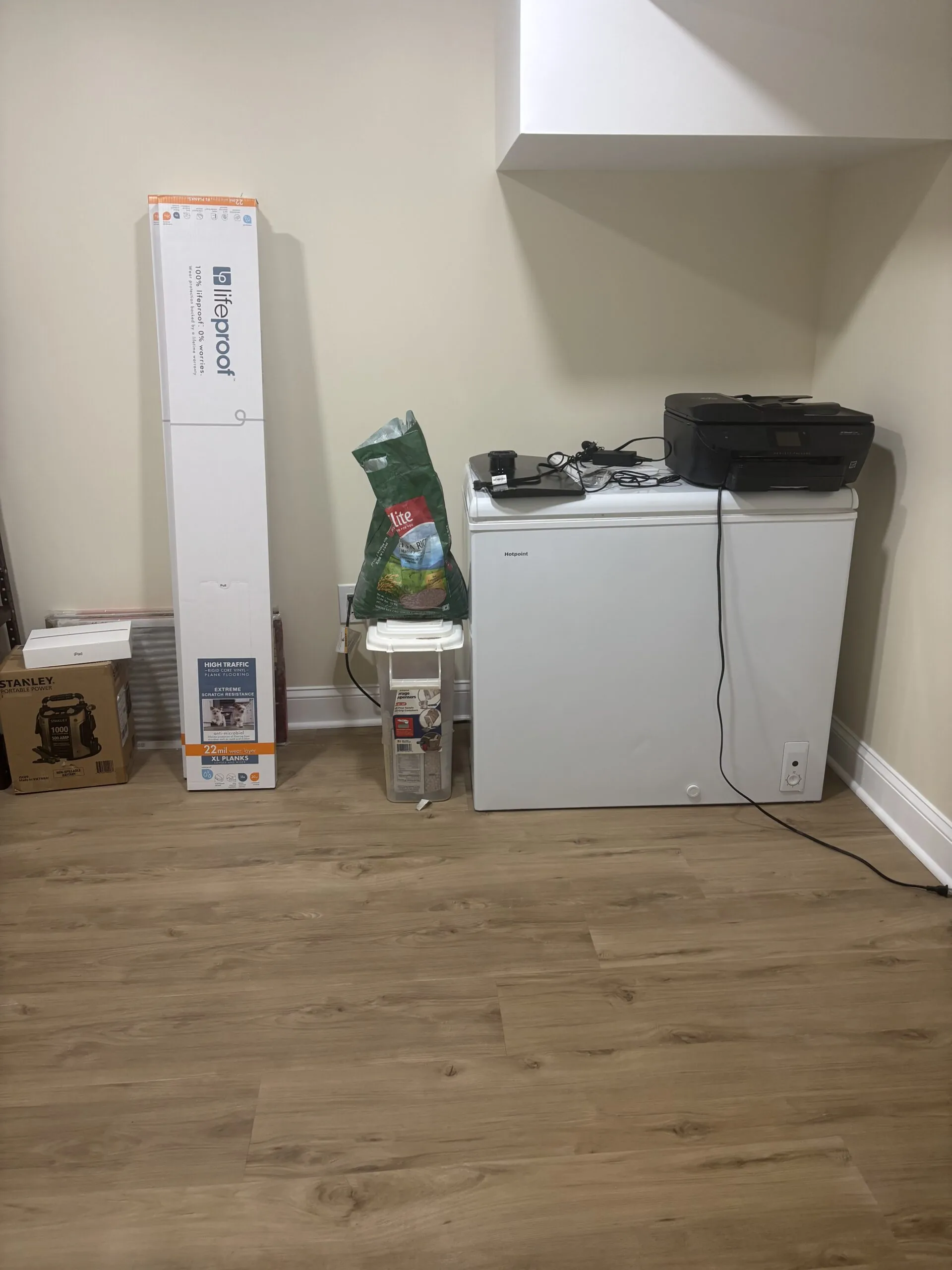 Finished basement with a sofa, vinyl wood floor, and recessed lights