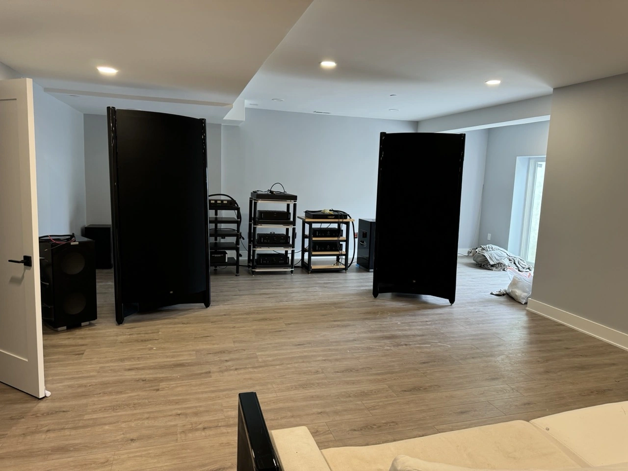 Finished basement with a sofa, vinyl wood floor, and recessed lights