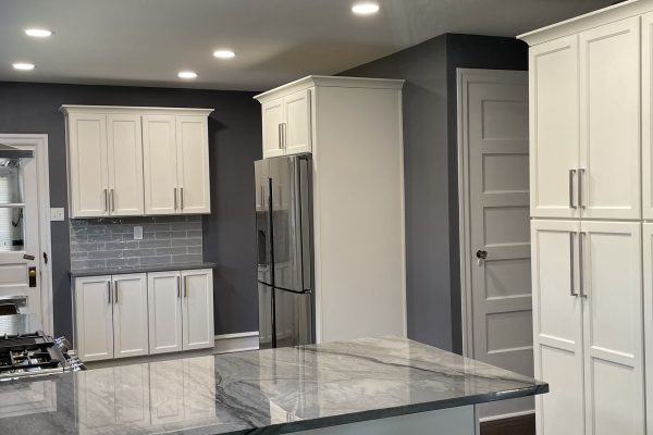 Spacious kitchen remodel with white shaker cabinets, stainless steel appliances, marble countertops, and subway tile backsplash in PA